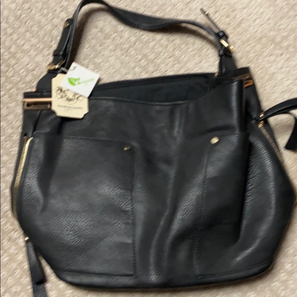 New black purse, never used with tags.  Vegan.